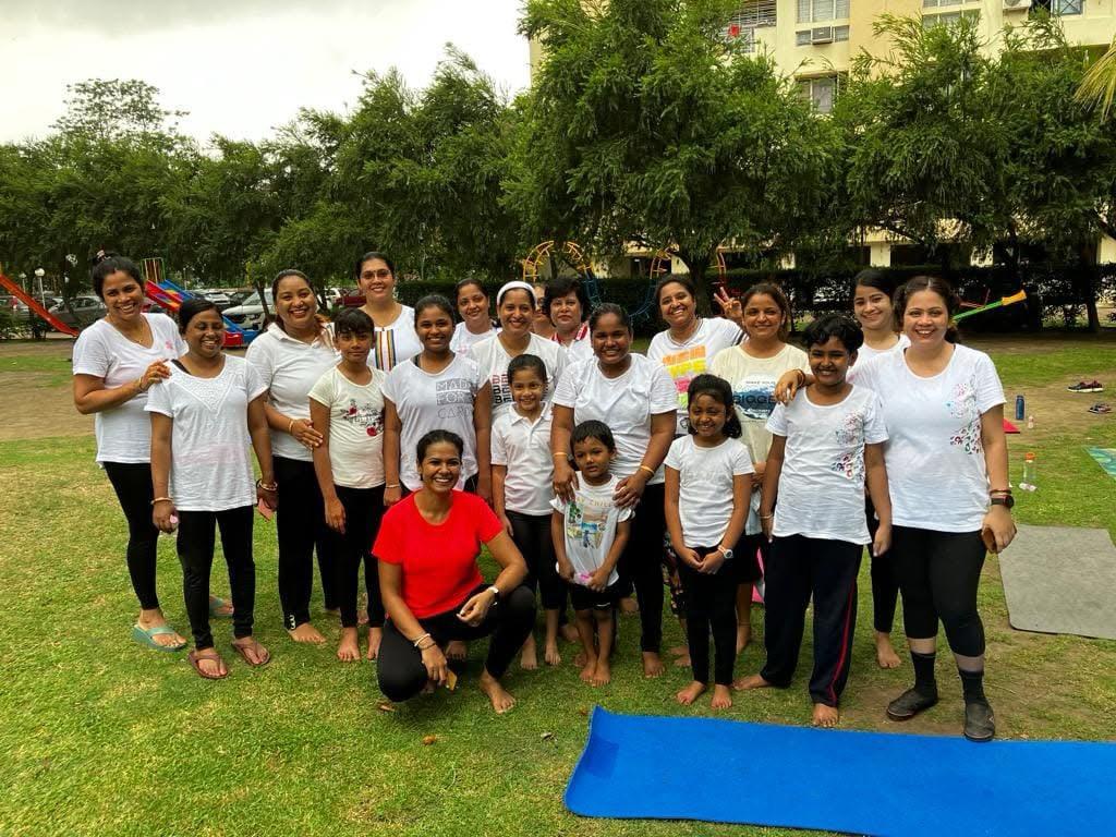 Outdoor yoga community group with Kanchan